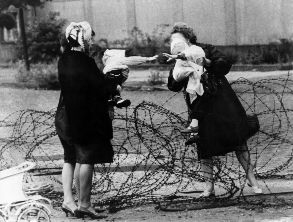 Imagem marcante de duas mulheres com seus bebês separadas por arames farpados durante a Operação Rosa